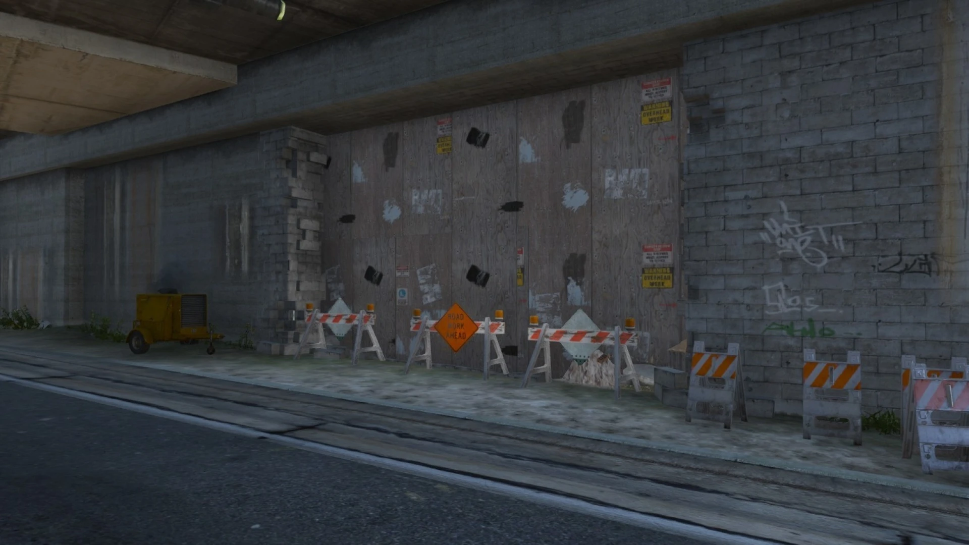 Closed tunnel mlo with barriers, debris, and moody concrete lighting